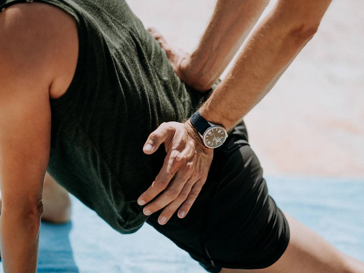 Hands performing manual therapy on someone's back during recovery